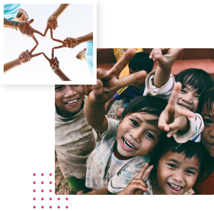 Volunteers joining hands, and children waving at the camera